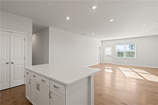 488 Village Ln, Fairburn, GA 30213 - kitchen with light wood-style flooring, a center island, open floor plan, white cabinets, and recessed lighting