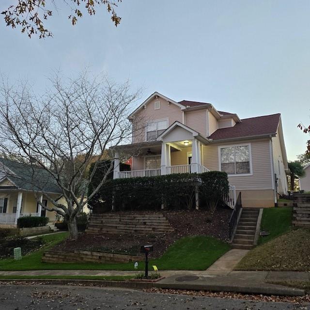 view of front of house with stairs and a porch