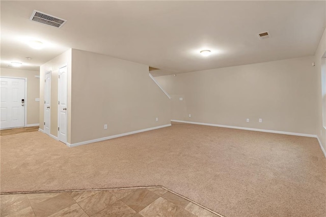 unfurnished room with light carpet