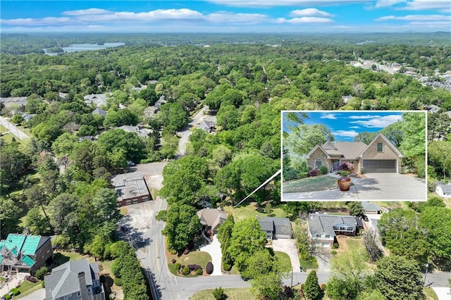 bird's eye view with a wooded view