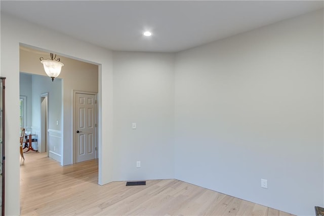 empty room featuring recessed lighting, light wood-style floors, and visible vents