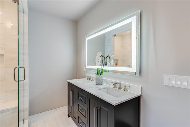 full bathroom with a sink, double vanity, and a stall shower