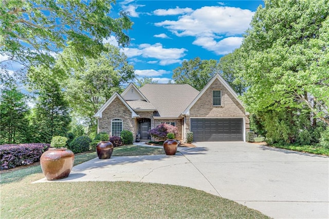 craftsman inspired home with stone siding, an attached garage, and driveway