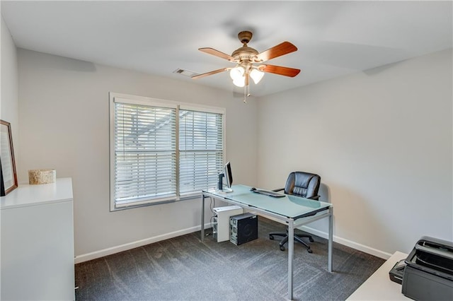 office area with dark carpet, visible vents, baseboards, and ceiling fan
