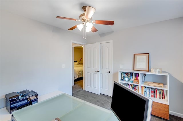 office with carpet floors and a ceiling fan