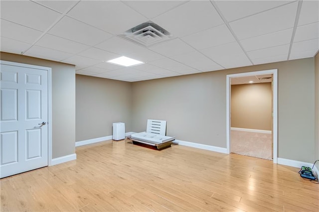 interior space featuring wood finished floors, visible vents, baseboards, and a paneled ceiling