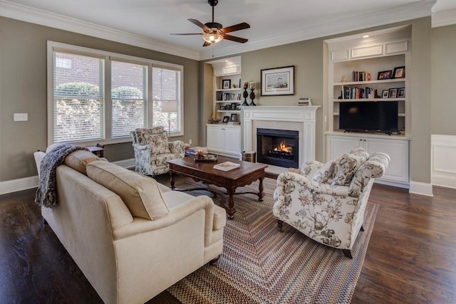 living room with dark hardwood / wood-style flooring, crown molding, built in features, and ceiling fan