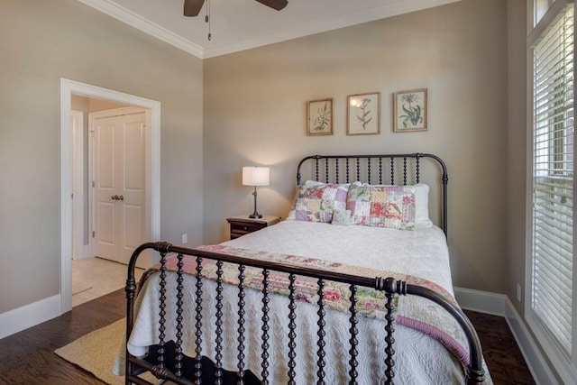 bedroom with hardwood / wood-style floors, ceiling fan, and crown molding