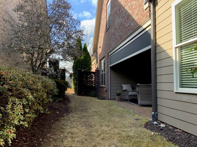 view of side of home featuring a lawn