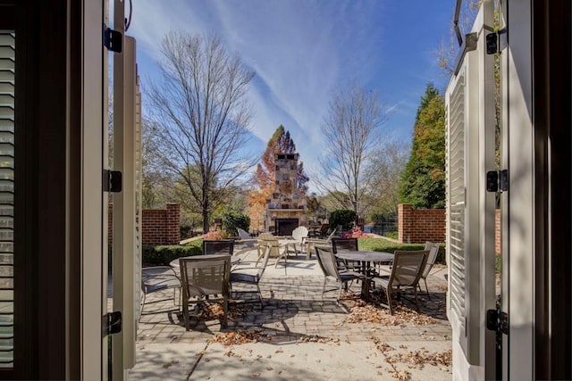 view of patio featuring an outdoor stone fireplace