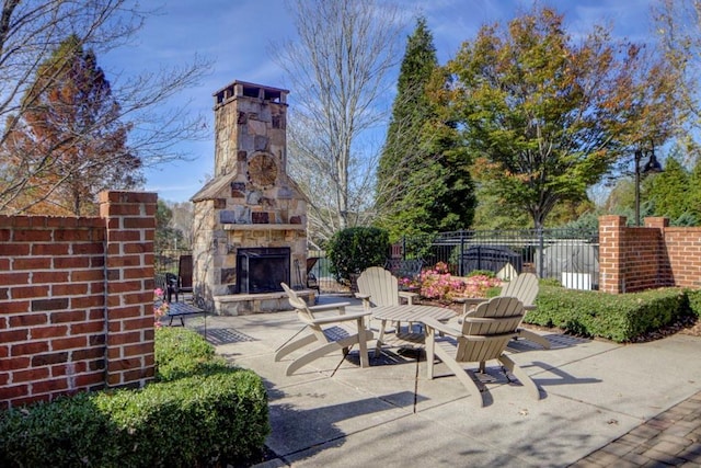 view of patio featuring an outdoor stone fireplace