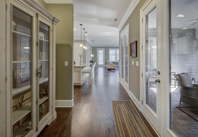 hall with dark hardwood / wood-style floors, crown molding, and french doors