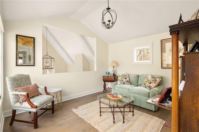 9229 Selborne Ln, Chattahoochee Hills, GA 30268 - living area featuring vaulted ceiling, wood finished floors, baseboards, and a chandelier