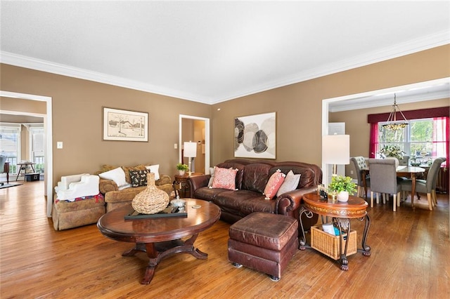 living room featuring crown molding and wood finished floors