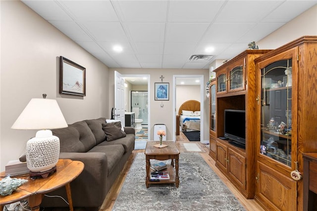 living room with recessed lighting, visible vents, and light wood-type flooring