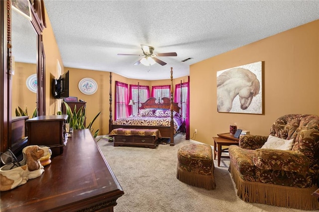 bedroom with carpet flooring, a ceiling fan, a textured ceiling, and visible vents