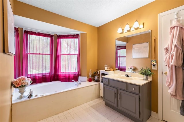 bathroom featuring vanity, a garden tub, tile patterned floors, and a textured ceiling