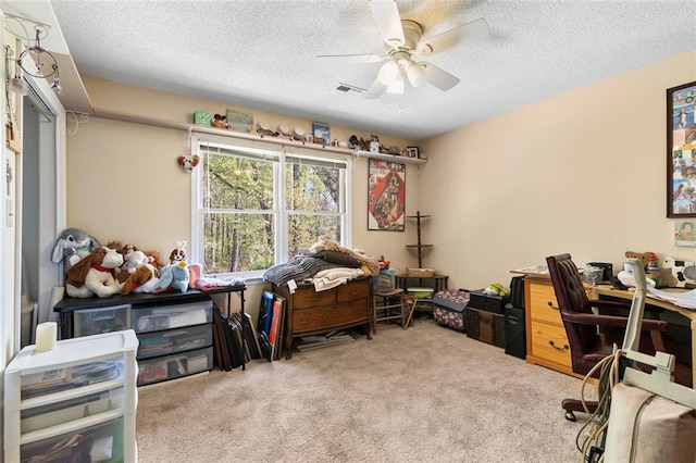 carpeted office space with visible vents, a textured ceiling, and ceiling fan