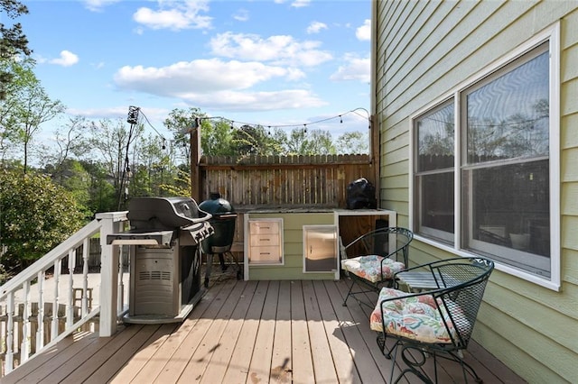 wooden deck featuring a grill