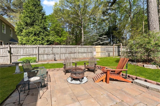 view of patio with a fenced backyard and a fire pit