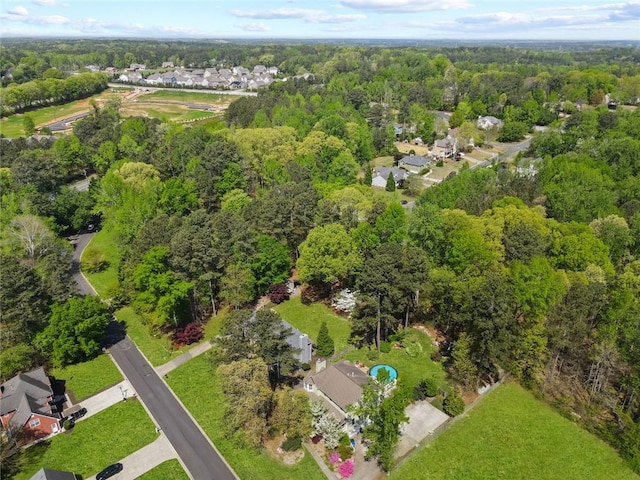 aerial view featuring a view of trees and a residential view