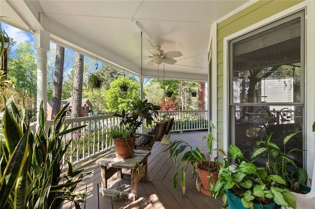 wooden deck with a porch and a ceiling fan