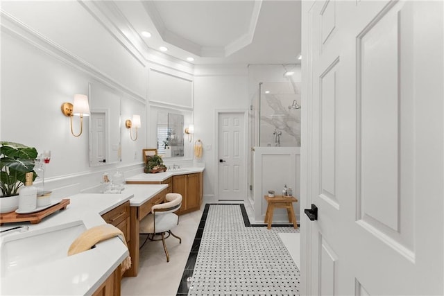 bathroom with tile patterned flooring, a tray ceiling, vanity, a shower with shower door, and ornamental molding