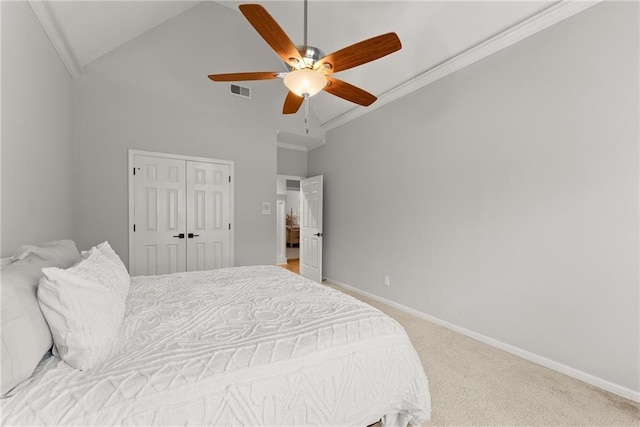 carpeted bedroom with ceiling fan, a closet, high vaulted ceiling, and crown molding