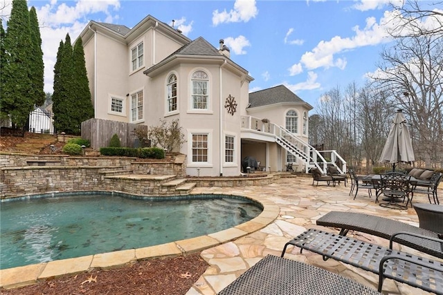 back of house with a patio