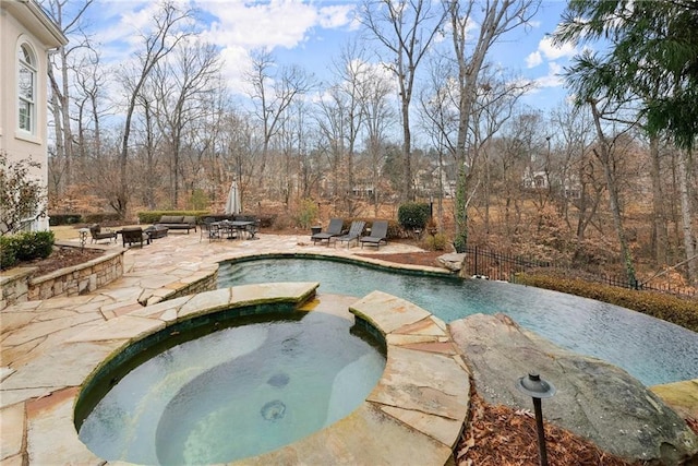 view of pool featuring an in ground hot tub and a patio