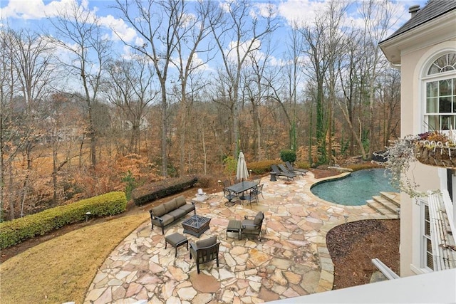 view of pool featuring a fire pit and a patio