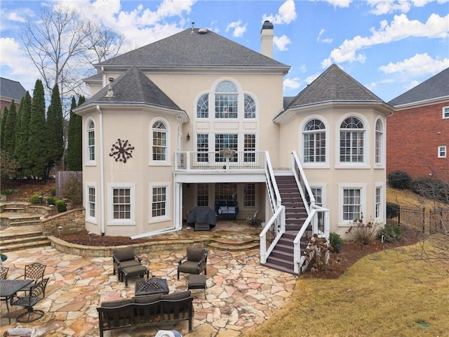 back of house with a patio, a balcony, and an outdoor fire pit