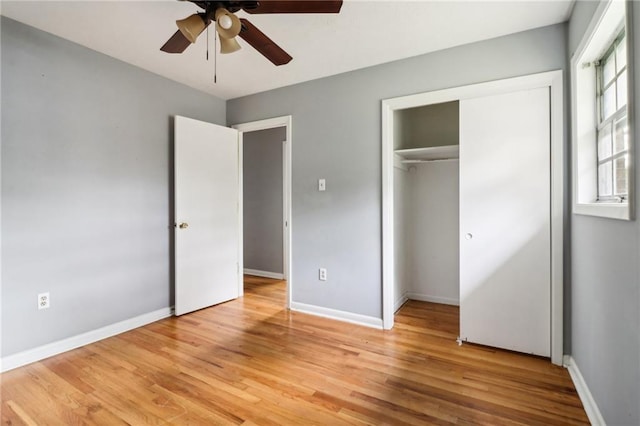 unfurnished bedroom with ceiling fan, light hardwood / wood-style floors, and a closet