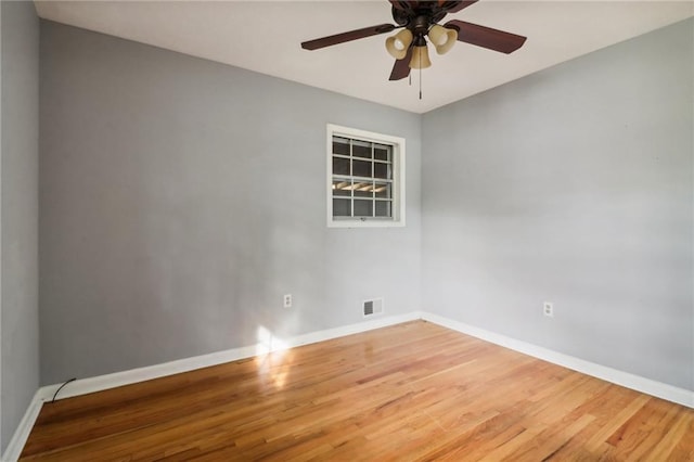 unfurnished room with ceiling fan and hardwood / wood-style flooring