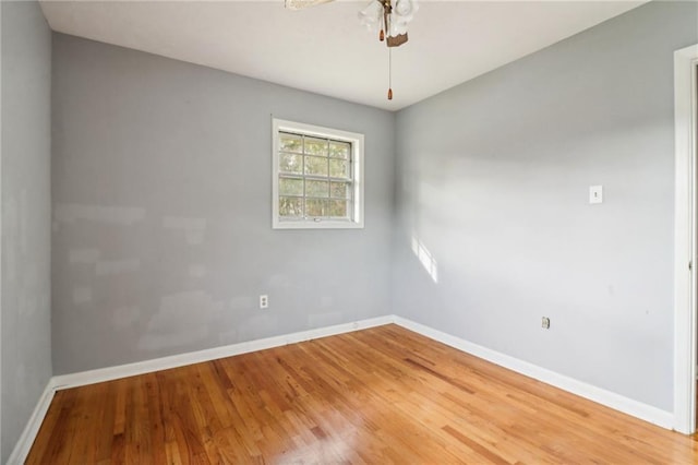 empty room featuring hardwood / wood-style floors and ceiling fan