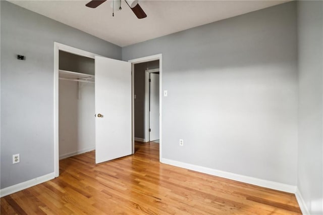 unfurnished bedroom with a closet, light hardwood / wood-style flooring, and ceiling fan