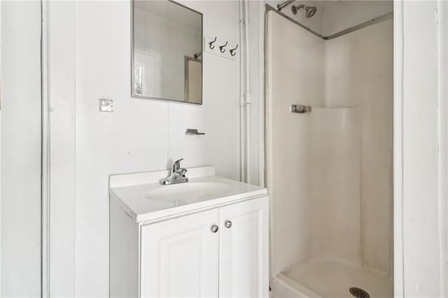 bathroom featuring a shower and vanity