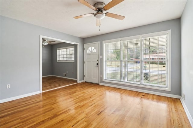 foyer entrance with ceiling fan and light hardwood / wood-style floors