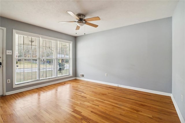 unfurnished room with ceiling fan and wood-type flooring