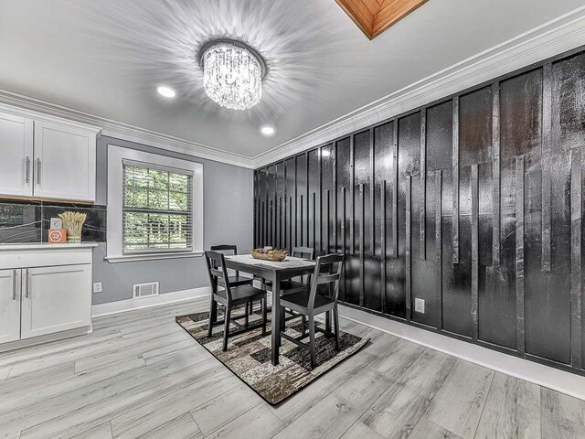 1564 Bubbling Creek Rd, Brookhaven, GA 30319 - dining space featuring baseboards, visible vents, ornamental molding, light wood-type flooring, and a notable chandelier