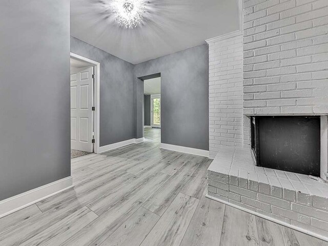 1564 Bubbling Creek Rd, Brookhaven, GA 30319 - unfurnished living room with light wood finished floors, a fireplace, and baseboards