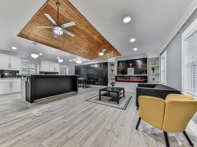 1564 Bubbling Creek Rd, Brookhaven, GA 30319 - interior space featuring light wood finished floors, a glass covered fireplace, wood ceiling, ornamental molding, and vaulted ceiling