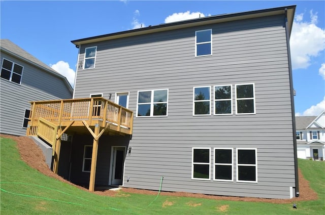 rear view of property featuring a lawn