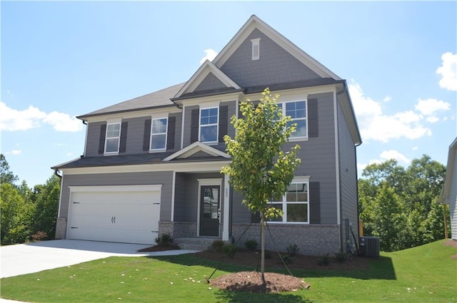 craftsman-style home featuring cooling unit, a front yard, and a garage