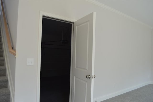 hall featuring ornamental molding and carpet floors