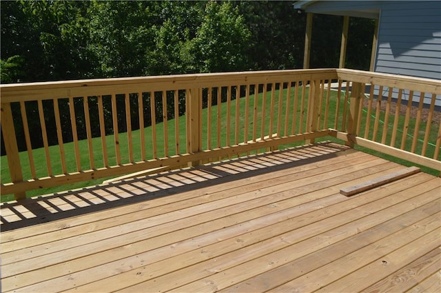 wooden terrace with a lawn