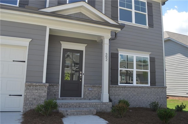 doorway to property with a garage