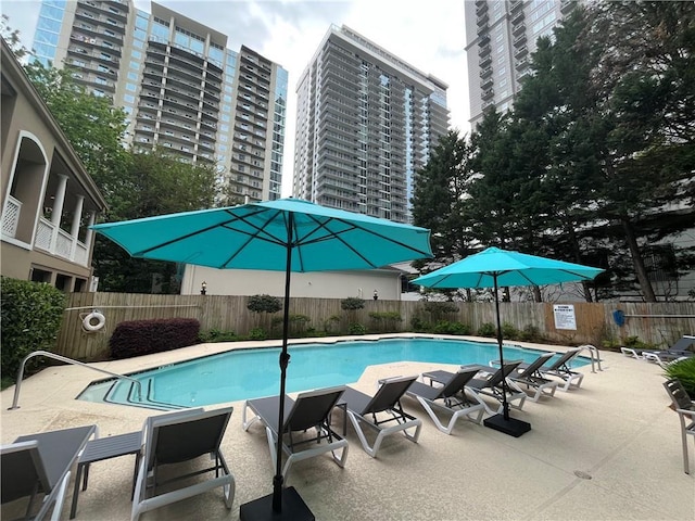 view of patio featuring a ceiling fan, outdoor dining space, and fence