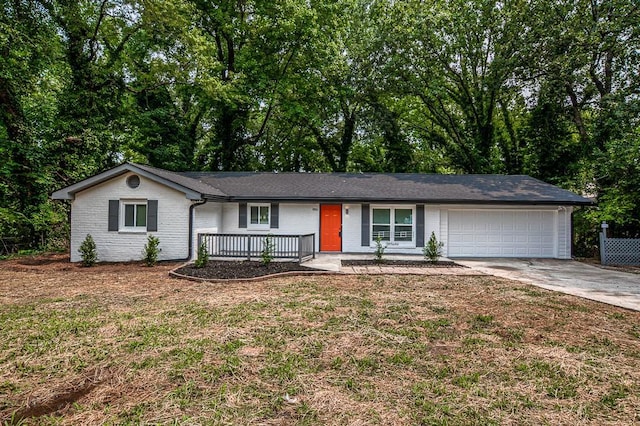 5640 Redan Cir, Stone Mountain, GA 30088 - single story home with a garage, driveway, covered porch, a front lawn, and brick siding