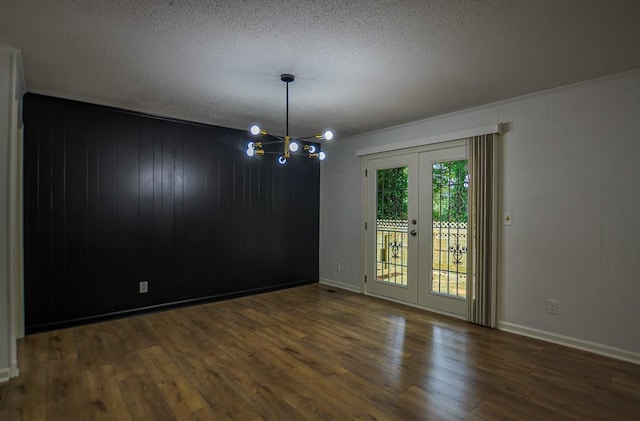 5640 Redan Cir, Stone Mountain, GA 30088 - empty room featuring a chandelier, a textured ceiling, wood finished floors, french doors, and baseboards